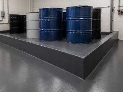 Coated containment curb around drum storage