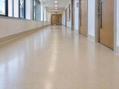 Seamless sand coloured floor down a school corridor