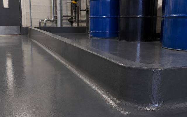 Chemical resistant floor coating with a containment curb in Red Deer