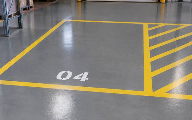 Warehouse floor marking around a numbered storage bay in Red Deer